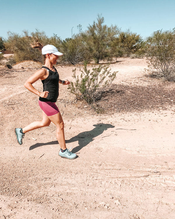 Woman running while wearing CURREX insoles.