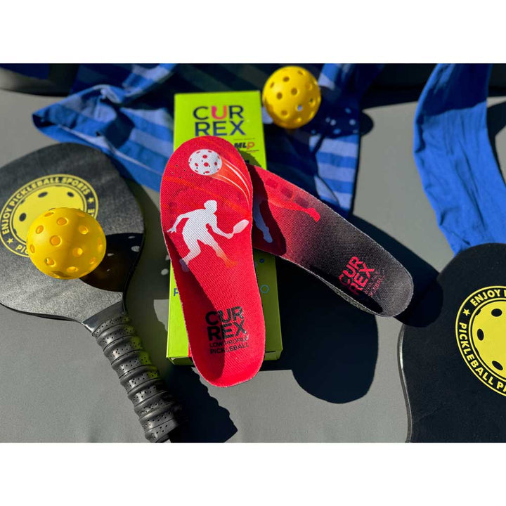 CURREX PICKLEBALLPRO Insoles sitting next to pickleball gear; pickleball paddles and pickleball ball #profile_high