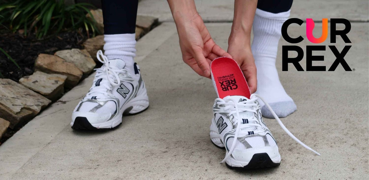 Hands putting a CURREX insole into a walking shoe