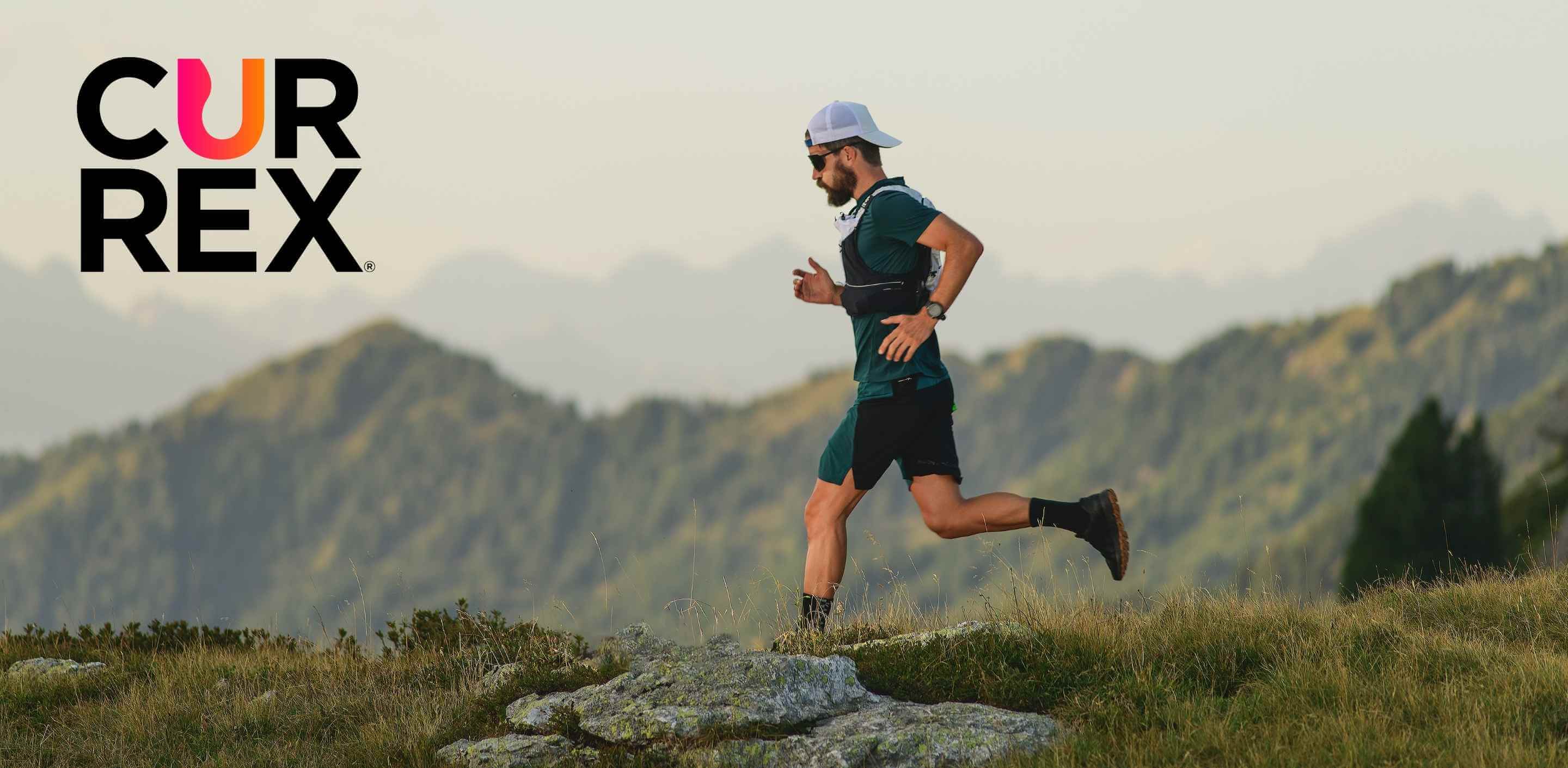 Man running on a mountain trail with the CURREX logo