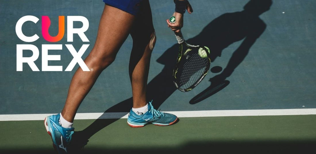 Person with a tennis racket getting ready to serve