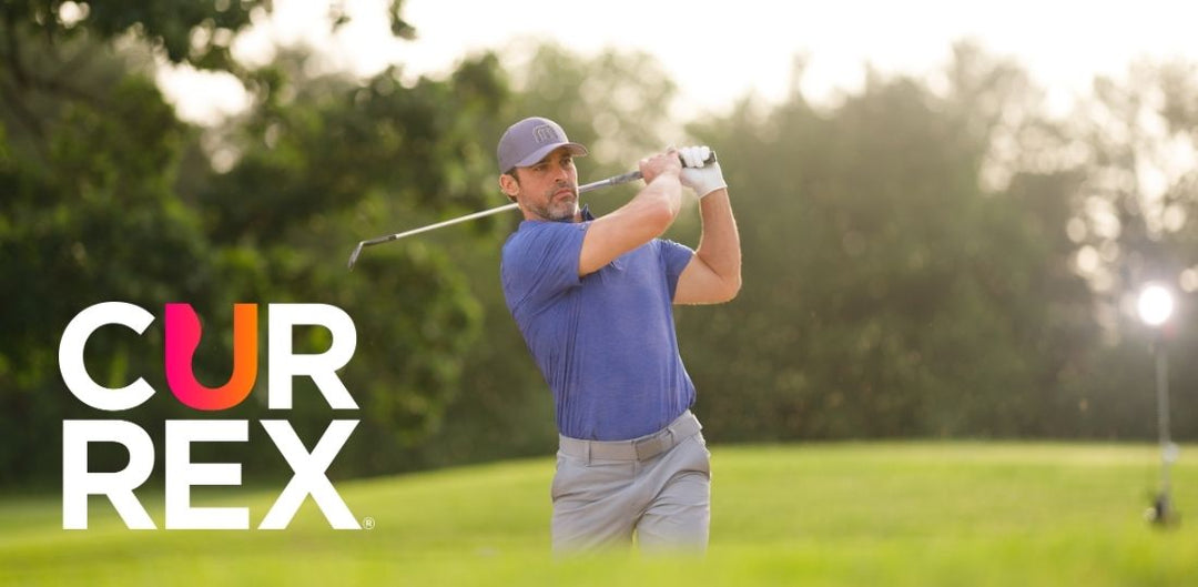 Man swinging a golf club, looking off into the distance