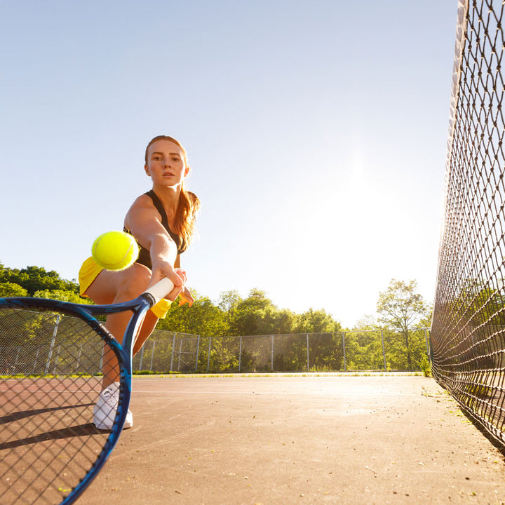 Woman playing tennis, hitting tennis ball with tennis racquet #profile_low