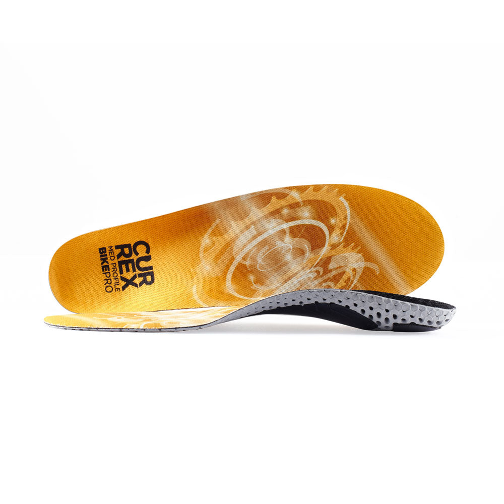 View of pair of yellow medium profile BIKEPRO insoles, one standing on side to show top of insole, second insole set in front showing its profile while toe is facing opposite direction #profile_medium
