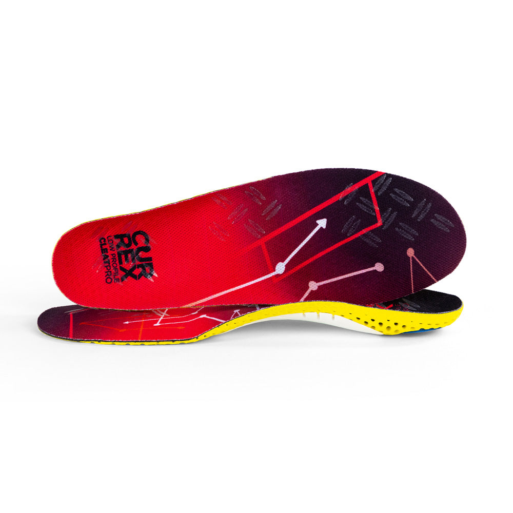 View of pair of red low profile CLEATPRO insoles, one standing on side to show top of insole, second insole set in front showing its profile while toe is facing opposite direction #profile_low