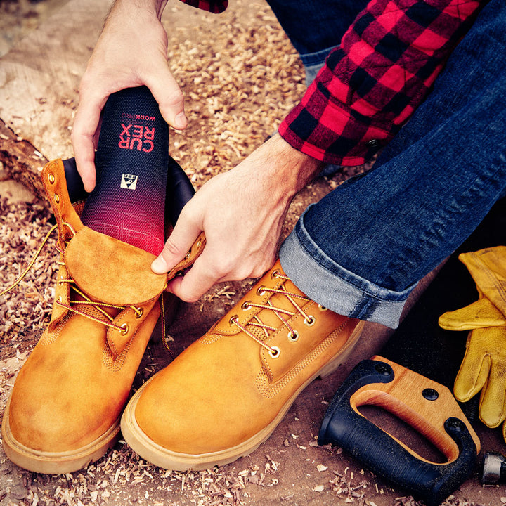 Man placing CURREX WORK low-profile red insole into work boot #profile_high