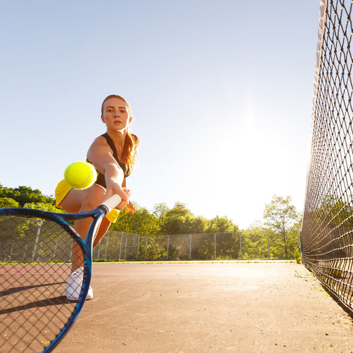 Woman playing tennis, hitting tennis ball with tennis racquet #profile_high