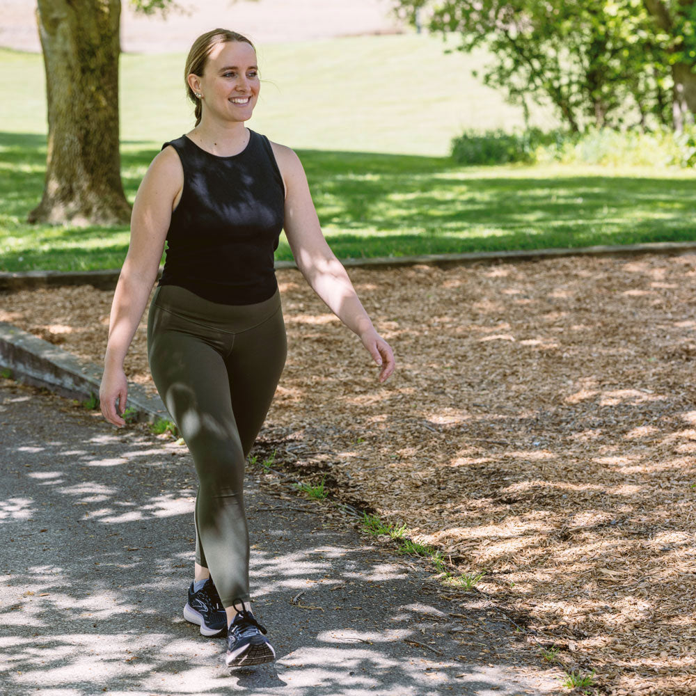 Woman walking at park while wearing CURREX ACTIVEPRO insoles in black shoes #profile_high