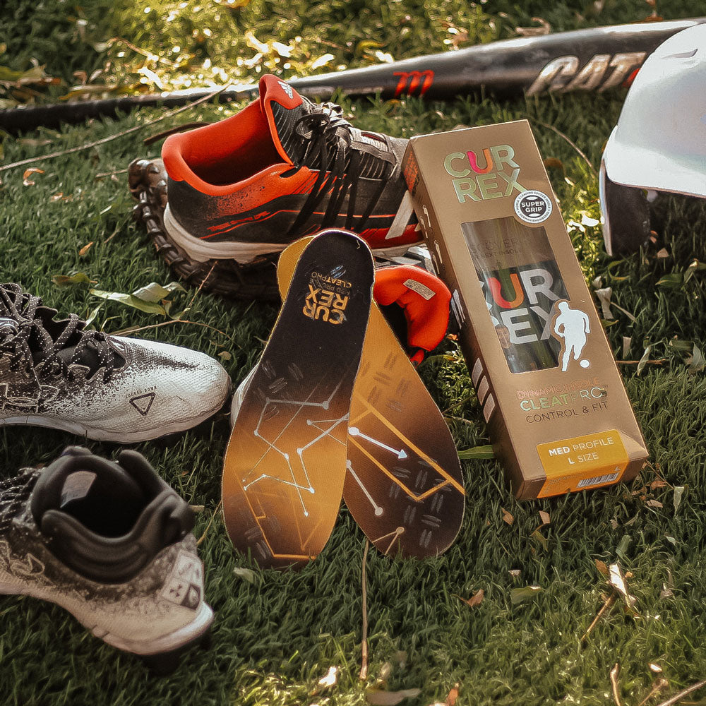 Yellow medium profile CURREX CLEATPRO insoles next to baseball mitt, baseball bat, baseball helmet, and cleats