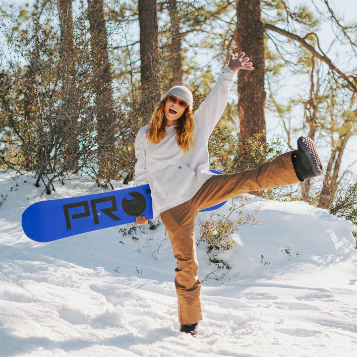 Woman standing in snow excited to go skiing #profile_high