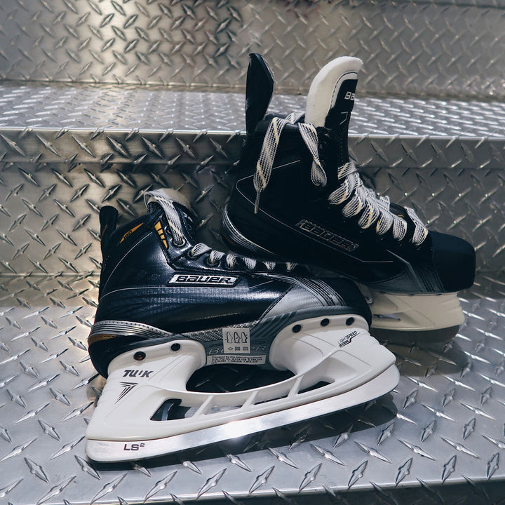 Hockey skates sitting on steel stairs #profile_high