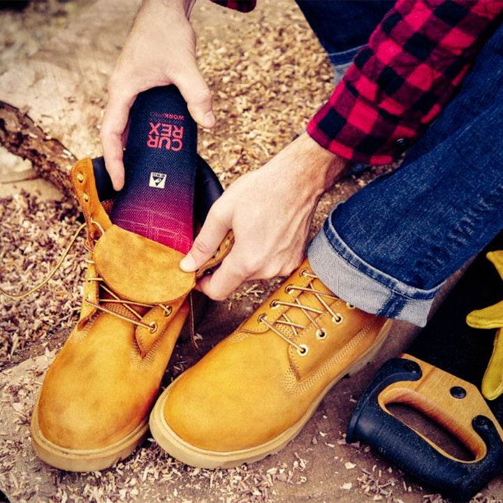 Man placing CURREX WORK low-profile red insole into work boot #profile_low